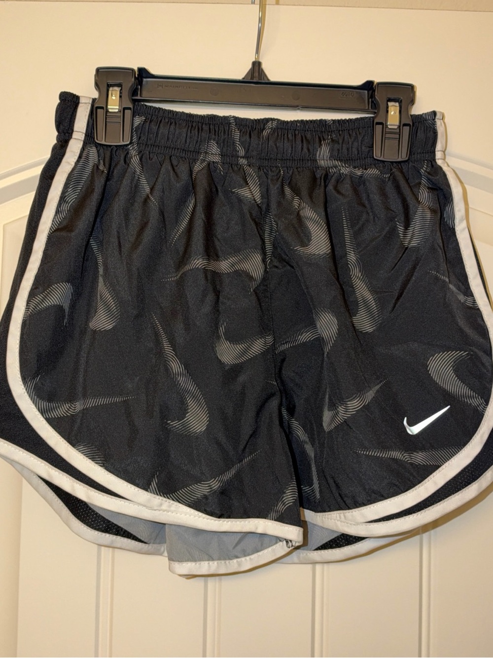 Nike Black Athletic Shorts with White Trim and Swoosh Pattern